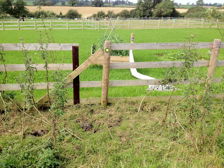 Photograph: A squeeze stile has been obstructed by nailing a wooden batten across it